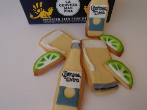 The corona bottles and beer glasses were easy to cut to shape. I printed images from Google and made sure they were on thick card to cut the cookies to shape (and still be able to be used for the fondant decorations after the cookies were baked.)  I kept fondant colours to a minimum and the details simple. The Corona labels were painted by hand with a paint brush and black food colour. 