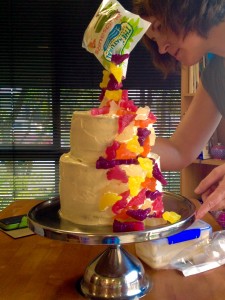 This is me placing some of the dinosaurs in clusters at the back of the cake, just so it's not bare for those who have a back-view.