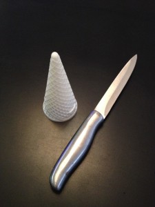Start with a cone, not cup shaped ice-cream cone and a sharp, serrated knife (I used a steak knife)